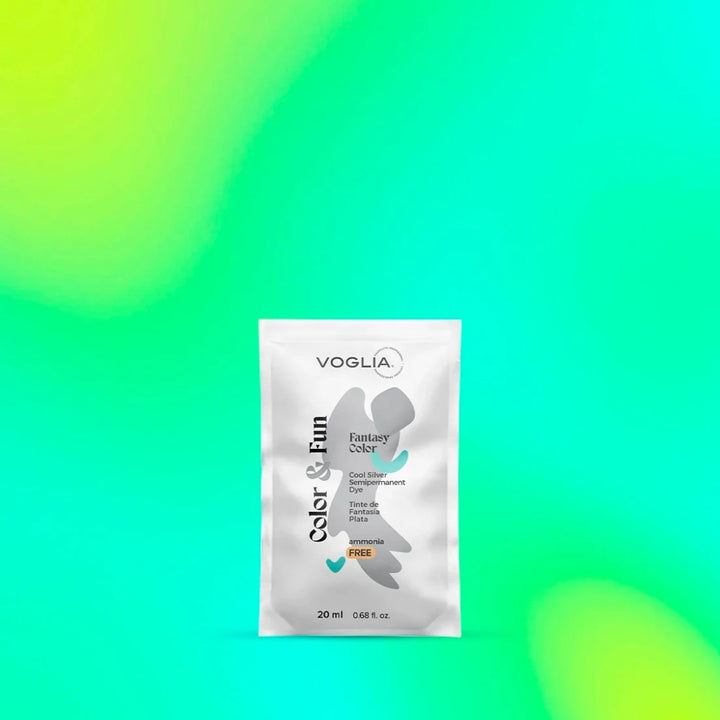 Silver hair dye sachet against vibrant gradient background